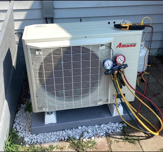 hvacunit Professional Caucasian HVAC Worker in His 40s Performing Heat Pump and Air Condition Units Seasonal Maintenance